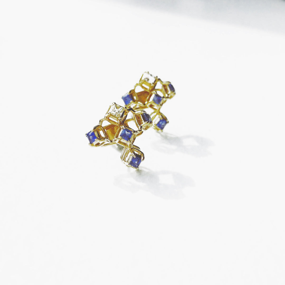 A pair of 14 karat yellow gold earrings with Blue and White Sapphires. This picture is only the detachachable top part. It consists of five square cut, top is white and the others are blue sapphires. They are standing like stargazing from the ground. 