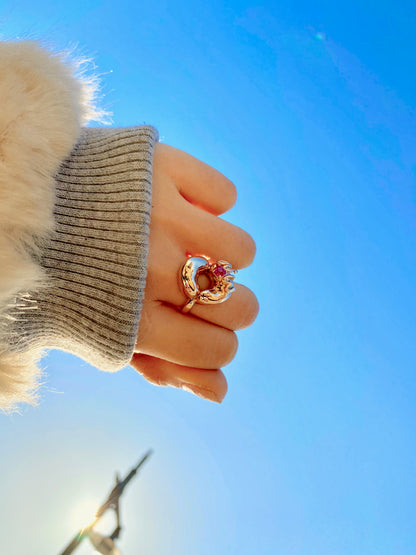 Wearing the 14 karat yellow gold ring with WOW letters with prongs setting cushion cut pink spinel.